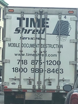 An image shows the rear door of an 18-wheeler trailer on the road. Black printed text, partially obscured by vertical frame bars, reads: “Time Shred Services Inc. Mobile Document Destruction, www.timeshred.com, 718 875-1200, 1800 989-8463.” This image evokes the concept of “shredding time,” linking the literal destruction of documents to the metaphorical fragmentation of temporal experience.