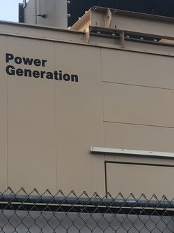 An image depicts the side of a tan-colored building with the words “Power Generation” written in black across its face. Taken on the campus where the artworks will be exhibited, this image invites reflection on the multiple meanings of “generation”—not only as the production of electrical power but also as a concept linked to biopower, where control is exercised over bodies and populations. The building thus stands as a symbol connecting industrial energy systems to broader structures of social regulation and the management of life itself.
