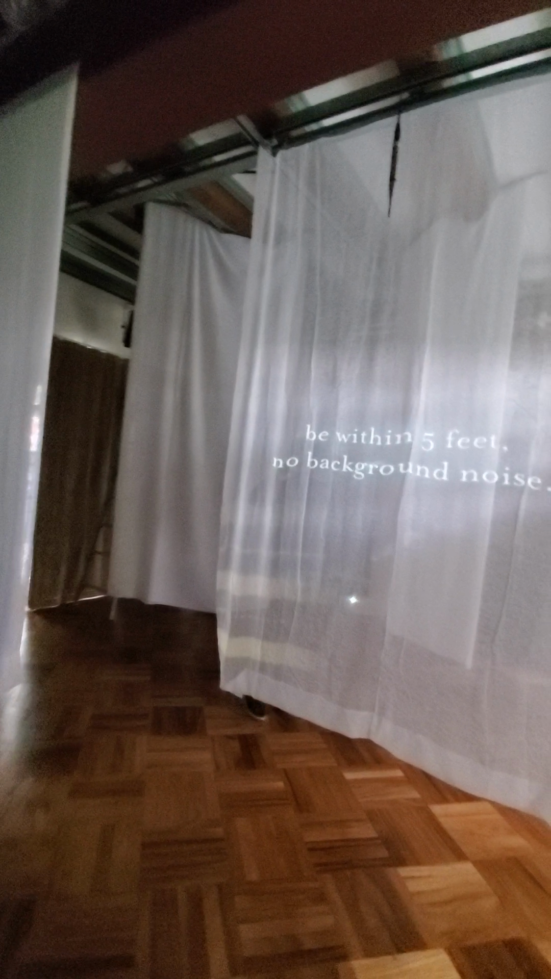 The artist experimented with different embodied experiences of video projected onto hanging panels. Here, the panels are hung in Berkeley’s Center for New Music Audio Technology. This space is comparatively wide and spacious.