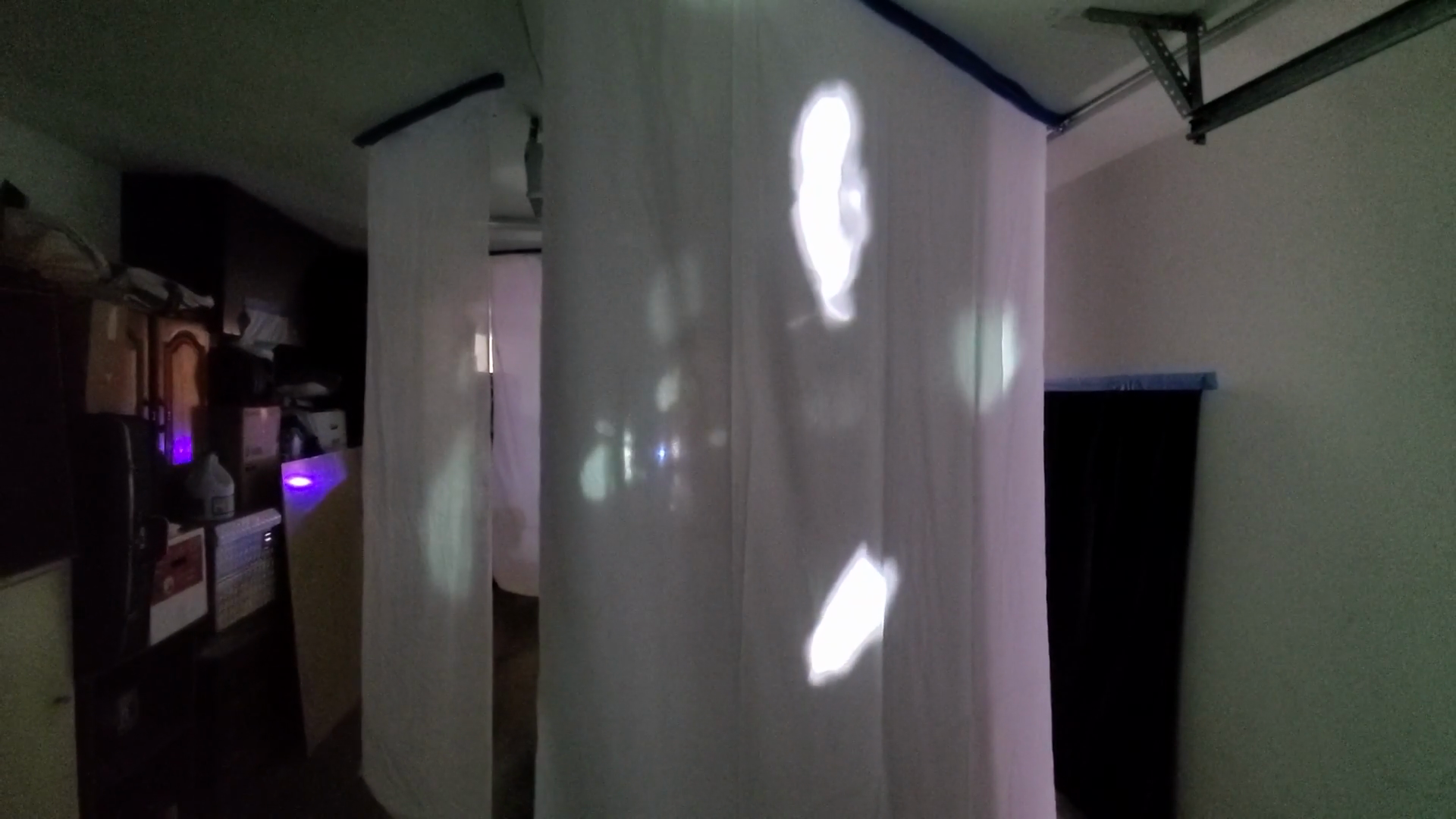 The artist experimented with different embodied experiences of video projected onto hanging panels. Here, the panels are hung in the artist’s garage, a long and linear space. This was the type of configuration she eventually chose for the exhibit at the Beall Center, because a tube-like space is evocative of the cochlea itself.